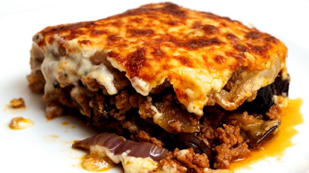 Moussaka is a casserole made by layering Aubergines (eggplant) with a spiced meat filling then topping it off with a creamy bechamel sauc